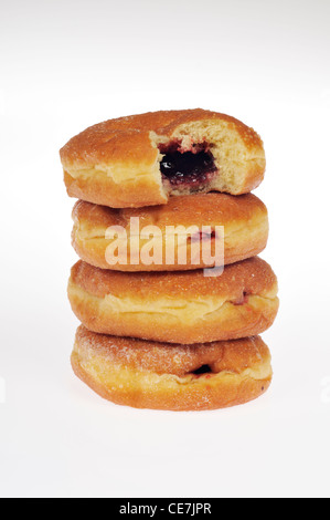 Stack of jelly-filled donuts with top one bitten on white background cutout. Stock Photo