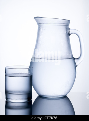 Pitcher of clear cold water with glass isolated on white background Stock Photo