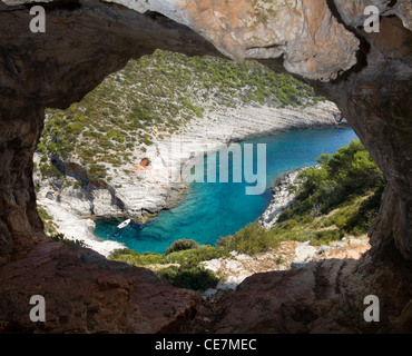 View from cave on small boat in cove Stock Photo
