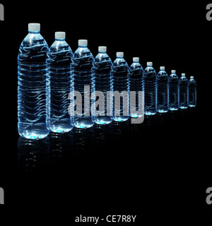 Several bottles of drinking water isolated on a black background Stock Photo