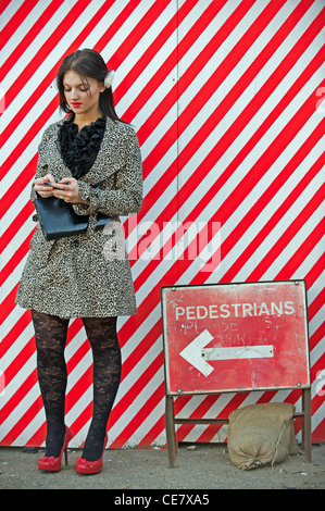 Young woman sending text message on mobile phone Stock Photo
