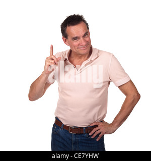 Attractive Smiling Middle Age Man Pointing Upwards or Wagging Finger with Cheeky Grin and Hand on Hip Stock Photo