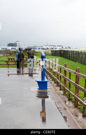 Spectators in the Viewing Park Area at Manchester International Airport with Talking Telescope on a Wet Day England UK Stock Photo