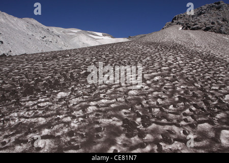 hiker snow field ash outside of crater Mount St Helens Volcano National monument Stock Photo