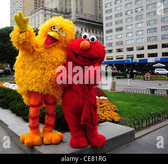 Two Sesame Street 'Big Bird' 'Elmo' entertainers posing backdrop green ...