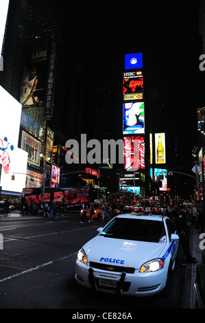 Night neon portrait NYPD police car parked 7th Avenue, towards West 46th Street and TKTS Duffy Square, Times Square, New York Stock Photo