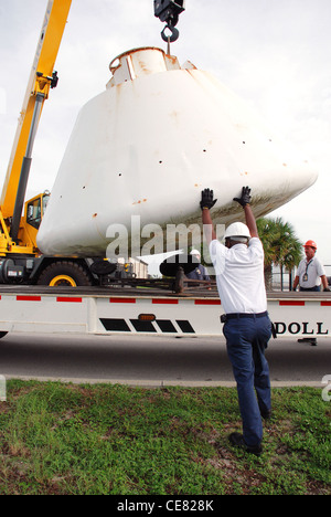 Workers help guide the 9,000-pound Apollo Boilerplate #1206 capsule onto a flatbed truck for transportation to a local refurbishment facility July 1 at Patrick Air Force Base, Fla. On loan here to the Air Force Reserve's 920th Rescue Wing from the Smithsonian Institute's Air and Space Museum, the capsule was once used by Air Force rescue units to train for astronaut recovery during the Apollo and Skylab space programs. Stock Photo