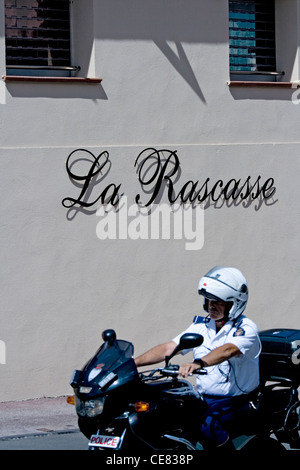 La Rascasse restaurant in Monte Carlo and a famous corner in the Formula 1 race. And a motorcycle policeman riding past. Stock Photo