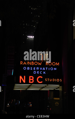 Night portrait entrance GE Building with neon adverts NBC Studios, Observation Deck, Rainbow Room, West 49th Street, New York Stock Photo