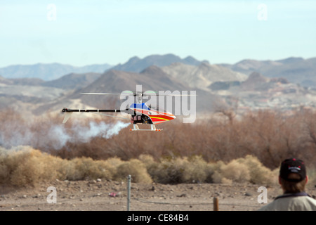 RC helicopter in flight in front of mountains Stock Photo