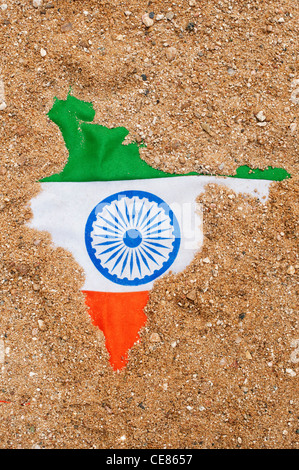 Indian flag showing through sand shaped like the map of India Stock Photo