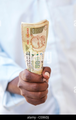 Indian mans hand holding a bunch of 500 rupee notes which were  demonetised in november 2016. India Stock Photo