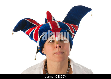 Woman is wearing a funny Brittish hat and is looking with cross eyes Stock Photo