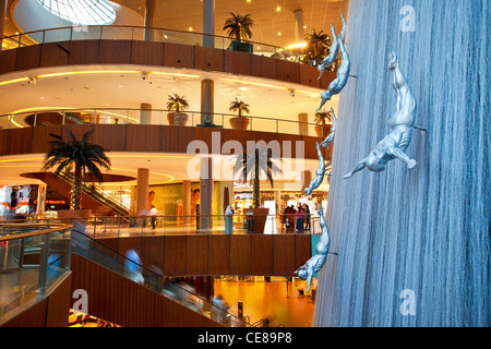Dubai, waterfall and sculptures of diving men inside Dubai Mall Stock Photo