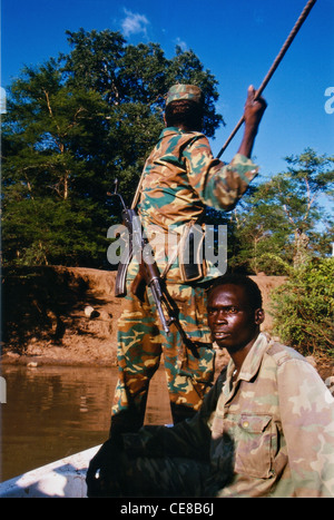 Sudan People's Liberation Army soldiers crossing a river by boat in Southern Sudan, Africa Stock Photo