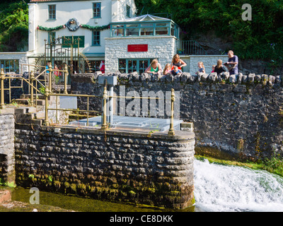 People looking into the the Cheddar Yeo weir and wishing pool at Cheddar Gorge, Somerset, England. Stock Photo