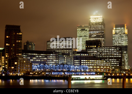 A long exposure of Canary Wharf on the river Thames, London, UK at night Stock Photo