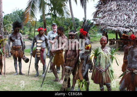 Traveller with remote tribal people in Papua New Guinea Stock Photo