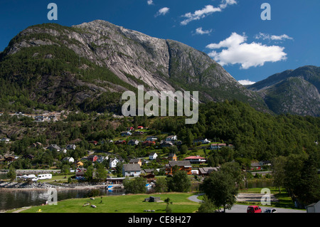 Eidfjord Norway hillside town mountain backdrop taken on bright sunny day with blue sky and white clouds Stock Photo