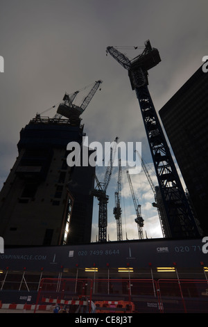 cranes looming over the Bishopsgate Tower site, also known as the pinnacle, Bishopsgate, London, UK Stock Photo