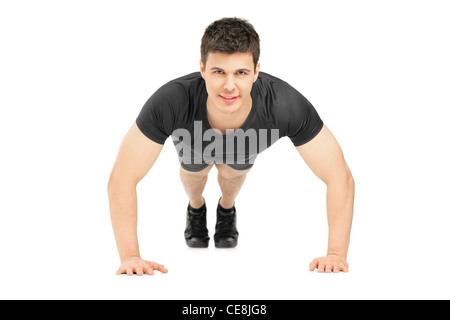 Handsome young man doing push ups Stock Photo