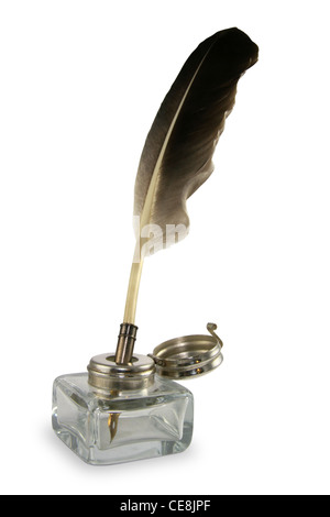 Feather quill pen in a circa 1890s to 1940s style glass inkwell. Stock Photo