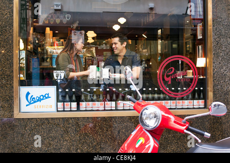 Couple sitting in window of cafe, talking and drinking coffee. Melbourne, Victoria, Australia Stock Photo