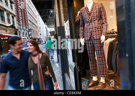 Couple walking past clothing store. Flinders Lane, Melbourne, Victoria, Australia Stock Photo