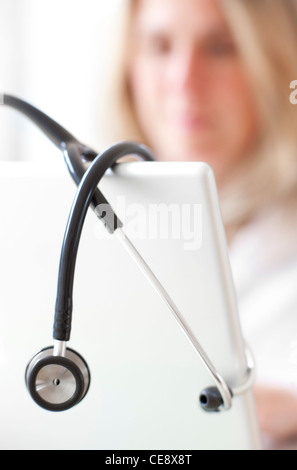 MODEL RELEASED. Doctor using a laptop. Stock Photo