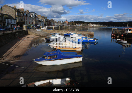 Boats in the harbour in front of the main street in Millport on the Ayrshire island of Millport Stock Photo