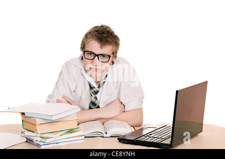 teenager student sits behind a desk isolated on white background Stock Photo