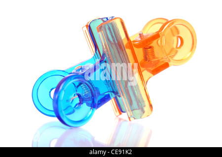 Blue and orange colored office paper clips on white background Stock Photo