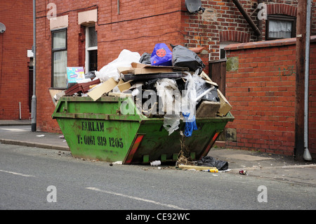 Overflowing rubbish skip Stock Photo - Alamy