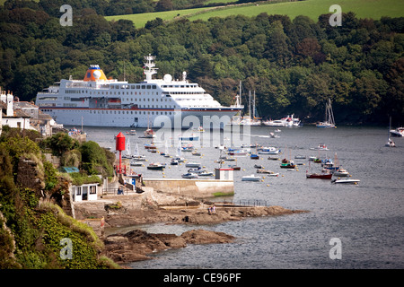 The cruise liner C. Columbus moored in the River Fowey estuary, Cornwall, UK with the Fowey to Polruan ferry jetty to the fore Stock Photo