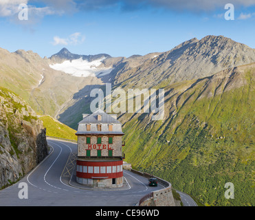 lonely, vintage hotel at Furka pass, set in barren alpine mountains in pass road bend Stock Photo