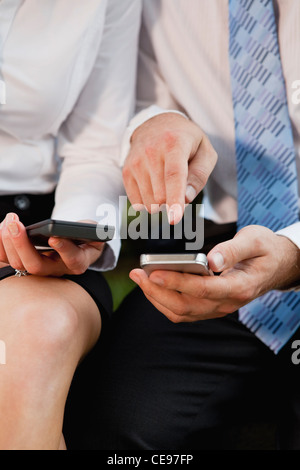 USA, Illinois, Metamora, midsection of business people using cell phones Stock Photo