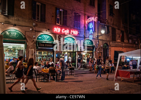 People eating and drinking in the street bars and restaurants at night. Old town Genoa (Italian, Genova) Italy Stock Photo