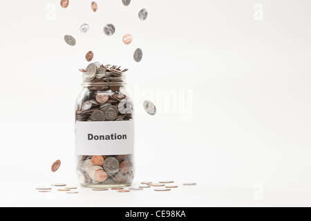 Studio shot of jar full of coins Stock Photo