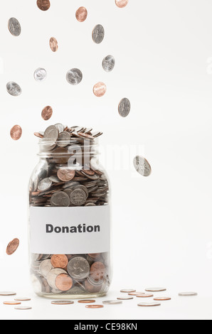 Studio shot of jar full of coins Stock Photo