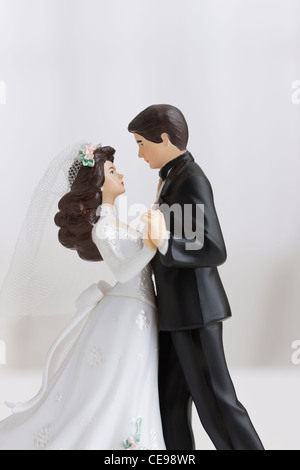 Studio shot of bride and groom figurines dancing Stock Photo