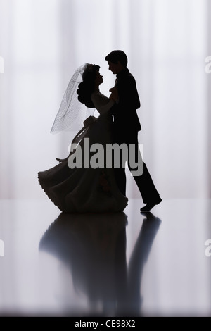 Studio shot of silhouettes of bride and groom figurines dancing Stock Photo