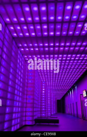Purple coloured lights front of house entrance to club room lobby lighting Stock Photo