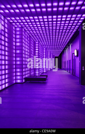 Purple coloured lights front of house entrancce to club room lobby lighting vertical full length Stock Photo