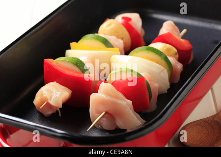 Raw chicken shish kebabs in a roasting pan Stock Photo