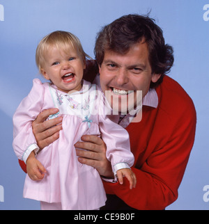 Father and daughter laughing in studio shoot, Berkshire, England, United Kingdom Stock Photo