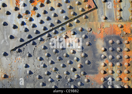 Old rusty rivets on large corroding steel plates of a train and auto Bridge Stock Photo