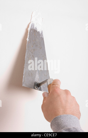 Putty Knife with Paste to Repair Wall Damage Stock Photo