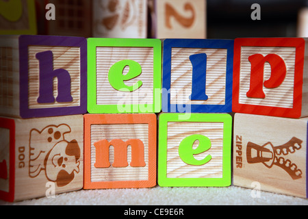 Building blocks spelling out 'help me' Stock Photo
