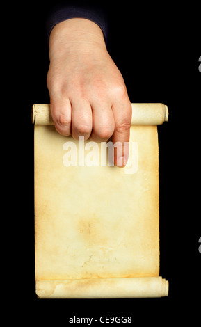 Hand holding old manuscript over black background Stock Photo