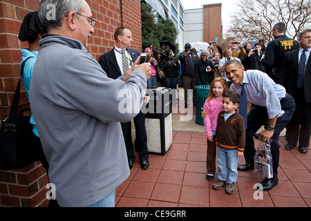 President Barack Obama poses with children outside a Best Buy store after doing some Christmas shopping December 21, 2011 in Alexandria, VA. Stock Photo